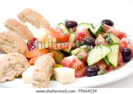 traditional Greek breakfast of crusty bread cake Kalamata olives capers tomatoes cucumber peppers chilis vegetables as photographed in Ios Cyclades Island Greece