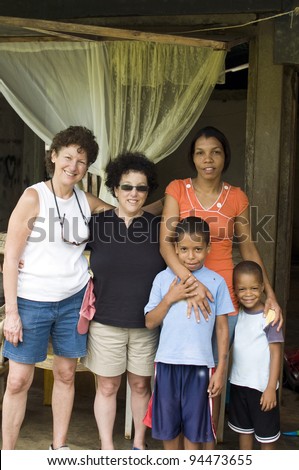 two white senior tourists with native mother sons family Corn Island Nicaragua