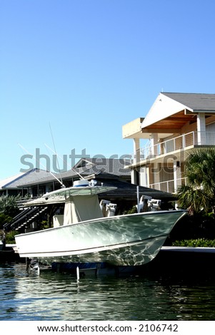 boat docked in front of beautiful house