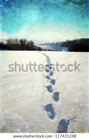 Vintage photo of footsteps in snow