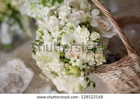 Vintage photo wedding bouquet of white roses in a basket