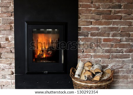 Fireplace in a brick wall and woods in basket