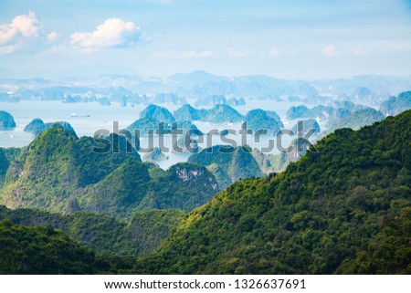 scenic view over Ha Long bay from Cat Ba island, Ha Long city in the background, UNESCO world heritage site, Vietnam