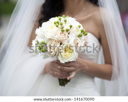 Bride holding beautiful white wedding bouquet