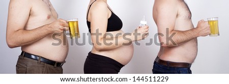 Two man with beer bellies holding pint of beer and pregnant woman holding nursing bottle