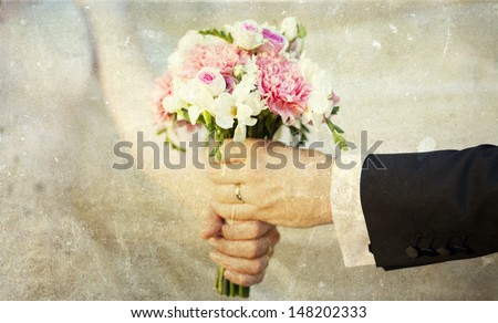 Groom handing over wedding bouquet - vintage photo