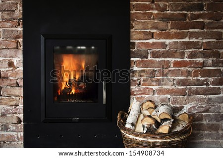 Fireplace in a brick wall and woods in basket