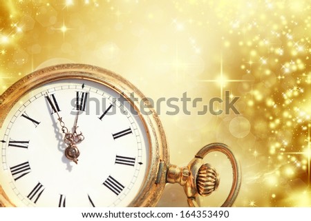 New Year\'s at midnight - Old golden clock with stars and snowflakes