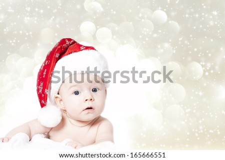 Portrait of a baby with Santa hat isolated on holiday background