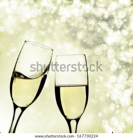 Vintage photo of glasses with champagne against holiday lights
