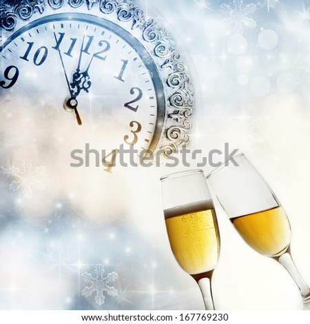 New Year\'s at midnight with champagne glasses and clock on light background