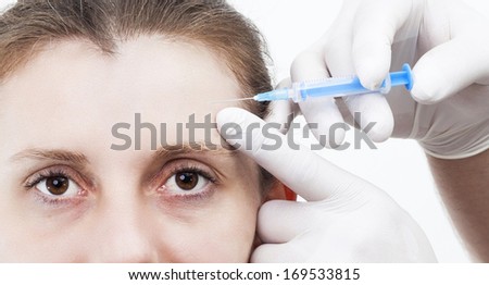 Woman getting injection to remove eye wrinkles