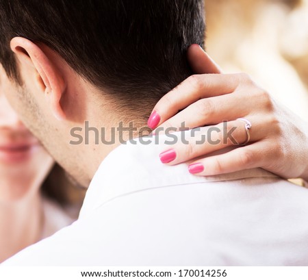 couple just about to kiss - focus on woman\'s hands with engagement ring