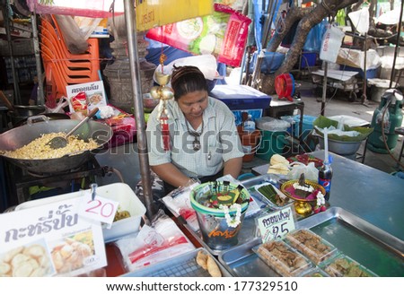 BANGKOK, THAILAND - JANUARY 24: Unknown vendors prepare and sell food on the street on Jan 24, 2014 in Bangkok, Thailand. Government figures indicate more 16,000 registered street vendors in Thailand.