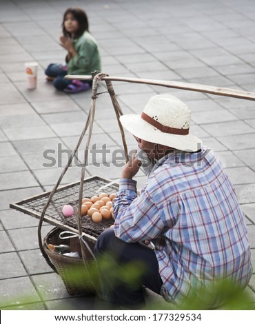 BANGKOK, THAILAND - JANUARY 24: Unknown vendor prepares and sells food on the street on Jan 24, 2014 in Bangkok, Thailand. Government figures indicate more 16,000 registered street vendors in Thailand.