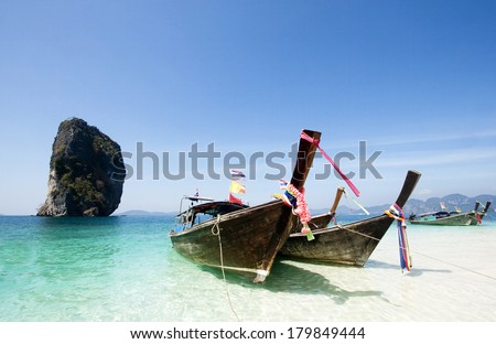 Adaman sea and wooden boat in Thailand. Tourism background with sea beach