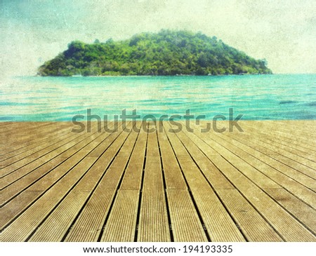 Vintage holiday background - wooden pier and island in the distance