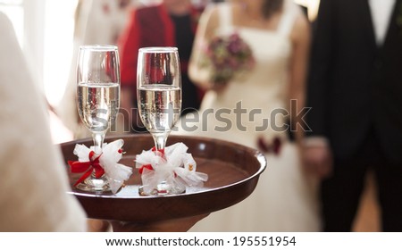 Waiter serving champagne to bride and groom