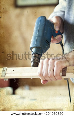 Man\'s arms drill lath in the workshop - vintage photo