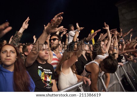 BONTIDA - JUNE 19: Crowd of partying people during a live concert at Electric Castle Festival on June 19, 2014 in the Banffy castle in Bontida, Romania.