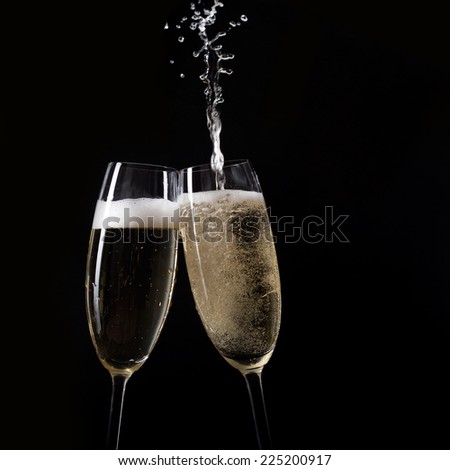 Champagne pouring in two glasses from a bottle