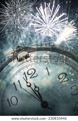 New Year\'s at midnight - Old clock against fireworks
