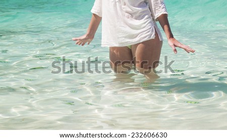 Woman legs in clear water