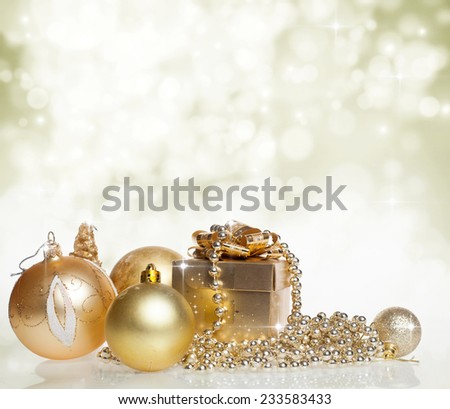 Christmas decorations and golden gift box on sparkling background - copy space