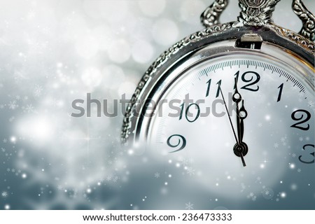 New Year\'s at midnight - Old clock with stars snowflakes and holiday lights