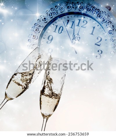 New Year\'s - toasting with champagne glasses against fireworks and clock close to midnight