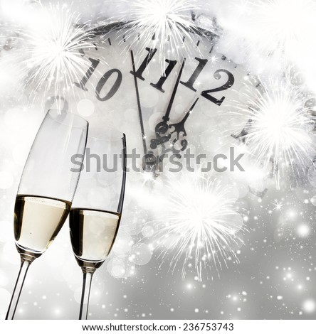 New Year\'s - toasting with champagne glasses against fireworks and holiday lights