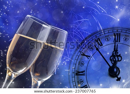 Glasses with champagne against holiday lights and clock close to midnight