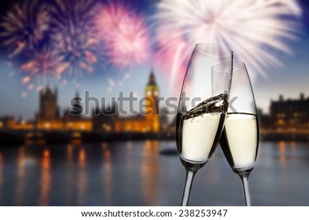 Toasting with champagne in London - Westminster abbey with fireworks in the background