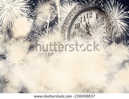 New Year\'s at midnight - old clock on bokeh background of holiday lights and fireworks