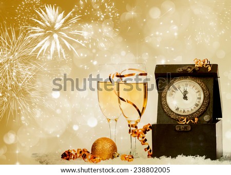 Glasses with champagne against fireworks and clock close to midnight