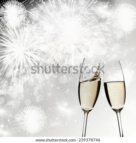 New Year\'s - toasting with champagne glasses against fireworks and holiday lights