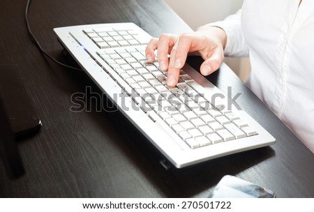 Closeup of business woman\'s hand typing on computer keyboard