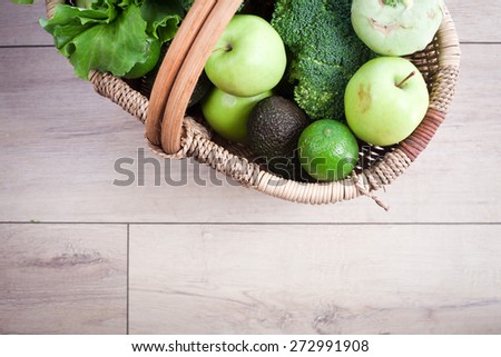 Green fruits and vegetables in basket