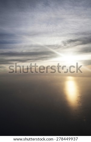 Sunset over the sea viewed from airplane