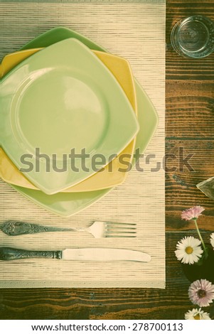 Table setting for two with empty plates - rustic wooden table