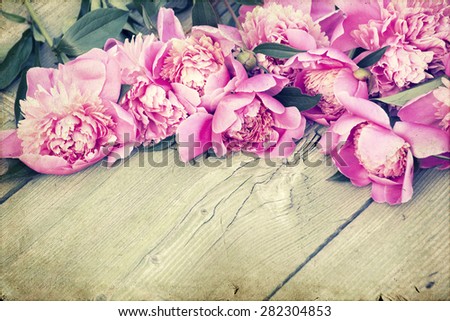 Vintage flower (peony) on wooden background
