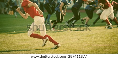 american football game with out of focus players in the background - sports concept, retro style photo