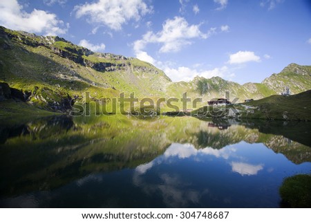 Beautiful landscape of glacier lake and high mountains reflecting in water