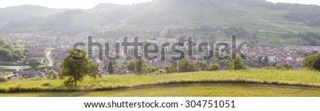 Panoramic rural landscape with village at sunset
