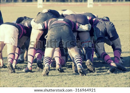 Rugby players fighting for ball - sports concept, retro style photo