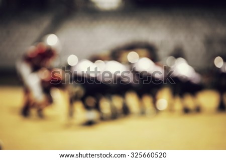 American football game - out of focus background of the field - retro styled photo