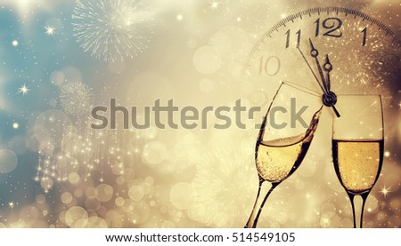 Glasses with champagne against fireworks and clock close to midnight - New Year, holiday background