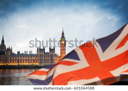 british union jack flag and Big Ben Clock Tower and Parliament house at city of westminster in the background - UK votes to leave the EU