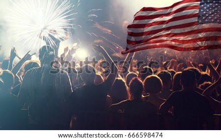 Crowd of people celebrating Independence Day. United States of America USA flag with fireworks background for 4th of July