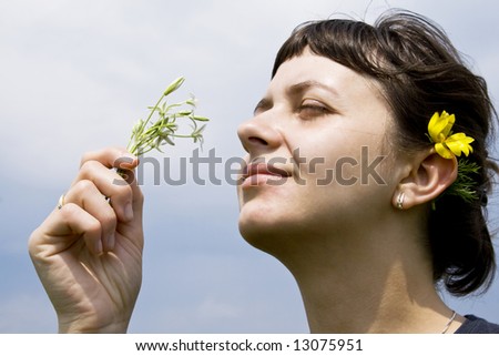 Young girl smelling wild flowers